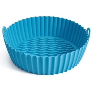 Blue silicone air fryer tray with corrugated sides and a wavy textured bottom, designed to be reusable and easy to clean.