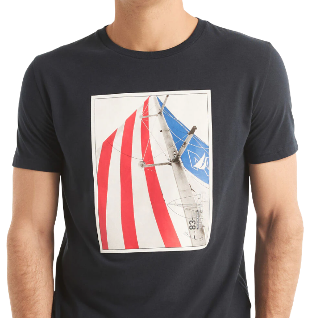 A navy blue T-shirt featuring a printed graphic of a sailboat with red and white striped sails and a blue sail bearing a white symbol.