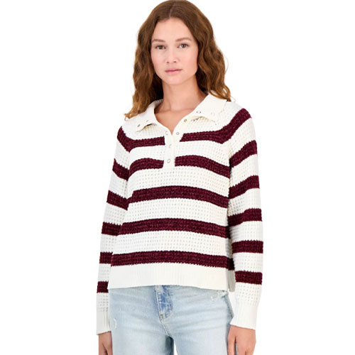 A woman wearing a white and burgundy striped collared sweater with buttons, paired with light blue jeans.