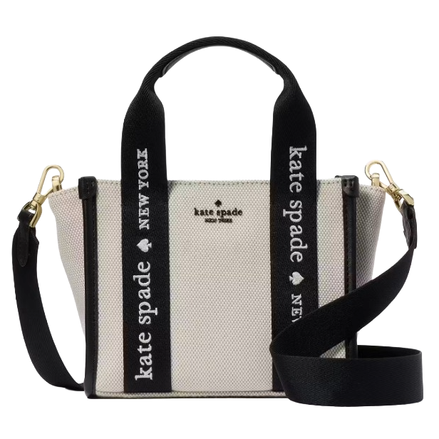 A Kate Spade New York handbag with black and white canvas, featuring \“Kate Spade New York\“ text on the straps and gold hardware.