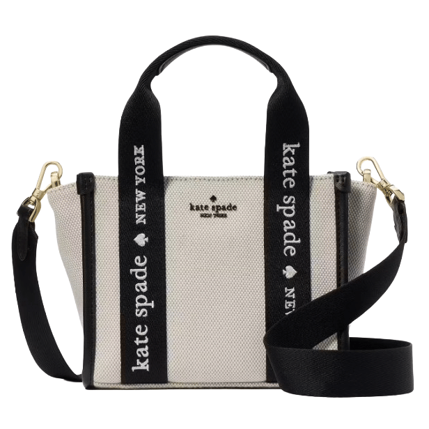 A Kate Spade New York handbag with black and white canvas, featuring \“Kate Spade New York\“ text on the straps and gold hardware.
