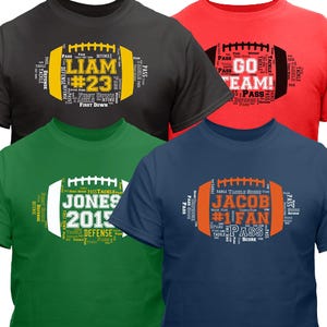 Four football-themed t-shirts in black, red, green, and blue, featuring personalized designs with names and words like \“Pass,\“ \“Defense,\“ and \“Tackle\“ arranged in a football shape.