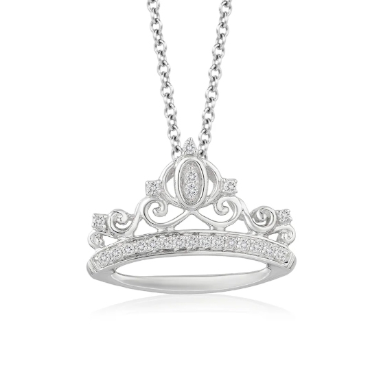 A necklace features a silver crown-shaped pendant inspired by Cinderella, adorned with intricate swirling designs and encrusted with sparkling diamonds. The pendant hangs from a silver chain, offering an elegant and whimsical appearance.