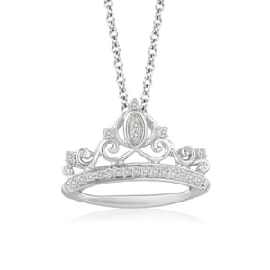 A necklace features a silver crown-shaped pendant inspired by Cinderella, adorned with intricate swirling designs and encrusted with sparkling diamonds. The pendant hangs from a silver chain, offering an elegant and whimsical appearance.