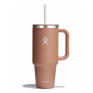A tan Hydro Flask tumbler with a handle and straw, featuring the Hydro Flask logo on its side.