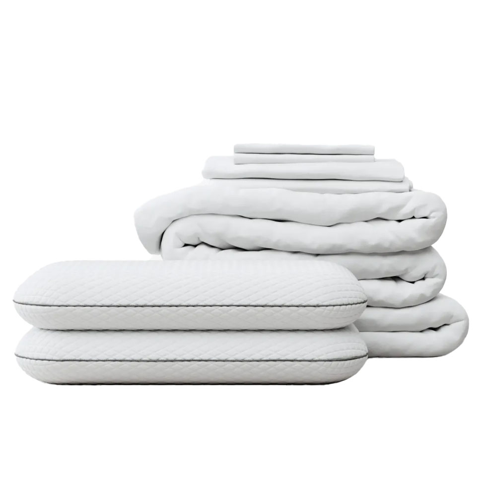 A set of white bedding items featuring a quilted texture, including two pillows, a folded blanket, and a stack of sheets.