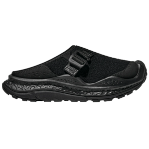A black slip-on shoe featuring a chunky, textured sole and an adjustable strap, designed for comfort and support.