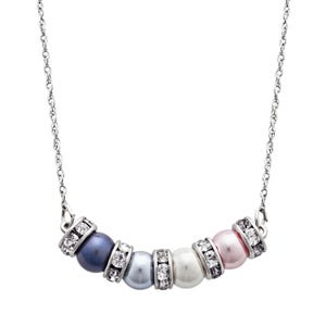 A necklace with a silver chain features five pearls in blue, light blue, white, and pink hues, each separated by sparkling rhinestone spacers.