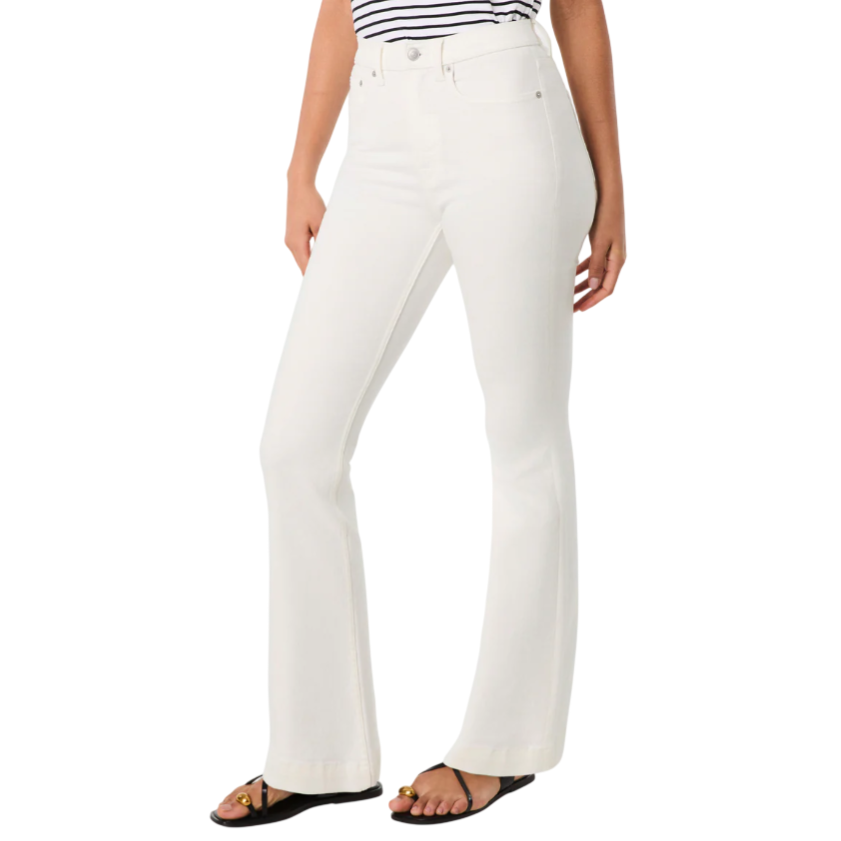 White flare jeans paired with a black-and-white striped top and black sandals featuring gold accents.