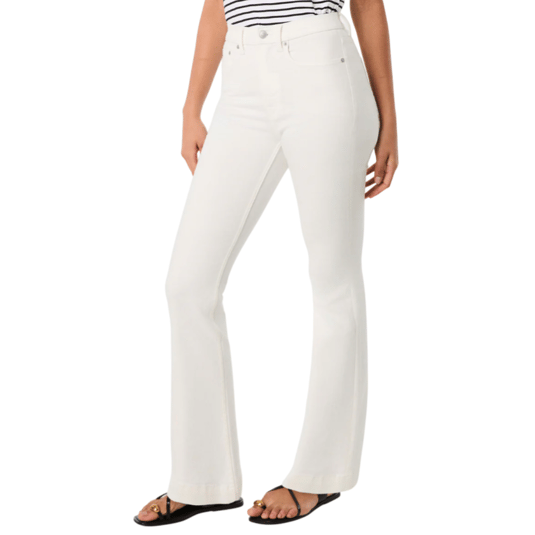 White flare jeans paired with a black-and-white striped top and black sandals featuring gold accents.