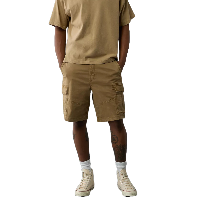 The Lived-In Cargo Shorts are brown, knee-length shorts featuring multiple pockets, including side cargo pockets. They are worn with a matching T-shirt and paired with socks and light-colored sneakers.
