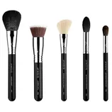 A set of five Sigma makeup brushes, including large powder, flat kabuki, tapered face, highlighter, and soft blend concealer brushes, with black handles and metal ferrules.