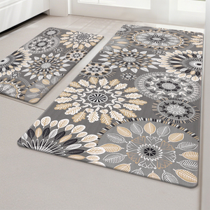 Two gray rugs with intricate mandala and leaf patterns in white, beige, and black adorn a light-colored floor.