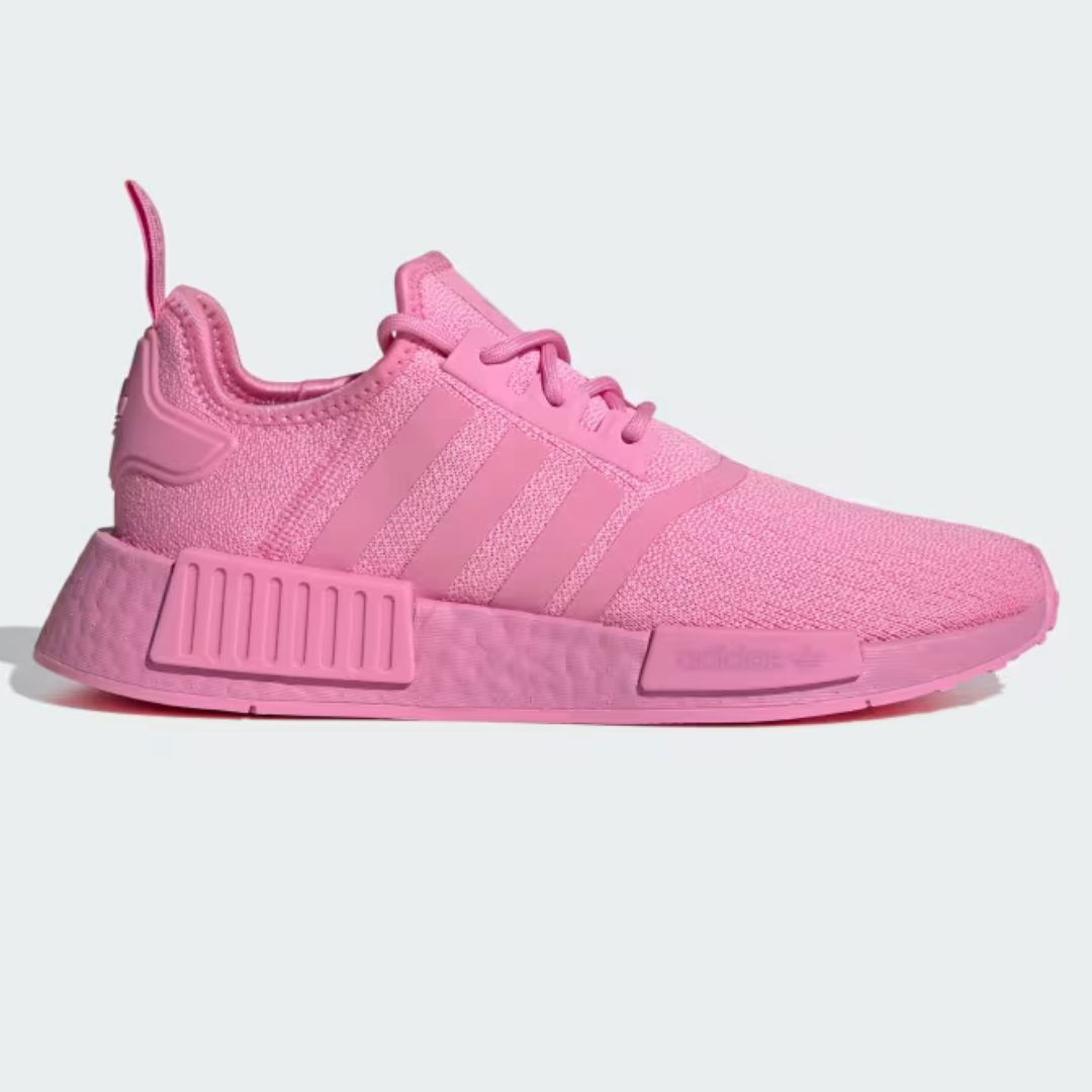 Pink Adidas NMD_R1 shoes with matching pink laces, three stripes, and a textured midsole.