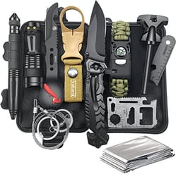 A compact survival kit featuring a tactical pen, flashlight, keychain knife, folding knife, emergency blanket, multi-tool card, bracelet with compass, and fire starter, all housed in a black waterproof case.