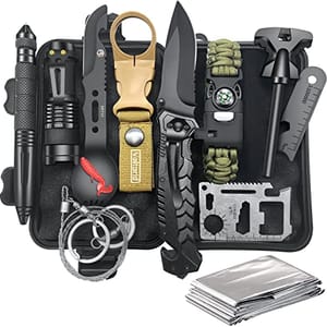 A compact survival kit featuring a tactical pen, flashlight, keychain knife, folding knife, emergency blanket, multi-tool card, bracelet with compass, and fire starter, all housed in a black waterproof case.