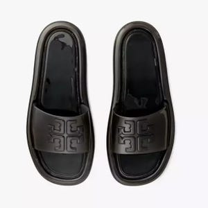 A pair of black slide sandals with a prominent embossed logo on the strap.