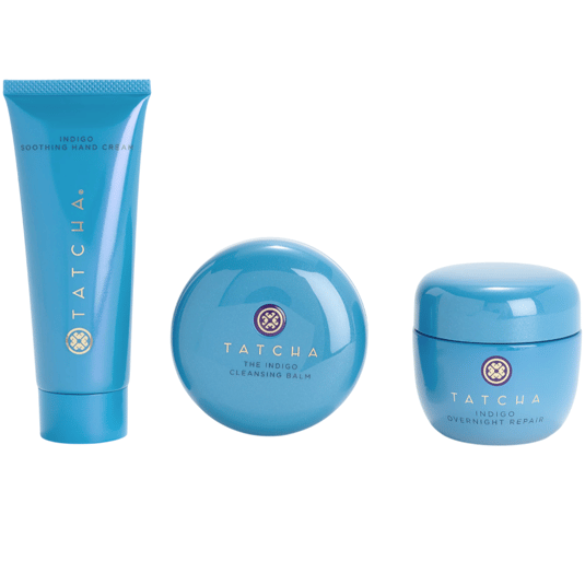 Tatcha Indigo collection: Soothing Hand Cream, Cleansing Balm, and Overnight Repair, all in blue packaging.