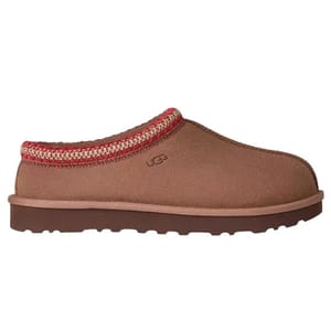 A brown slip-on shoe with a red and white patterned trim and rugged sole, featuring the UGG logo on the side.