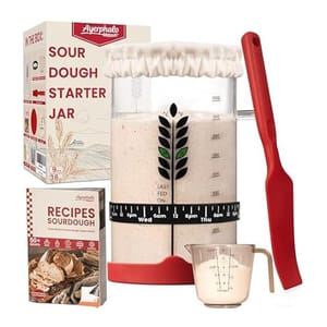 Sourdough Starter Kit includes a glass jar with measurements, a red spatula, a measuring cup, a fabric jar cover, a recipe book for sourdough, and instructions for feeding.