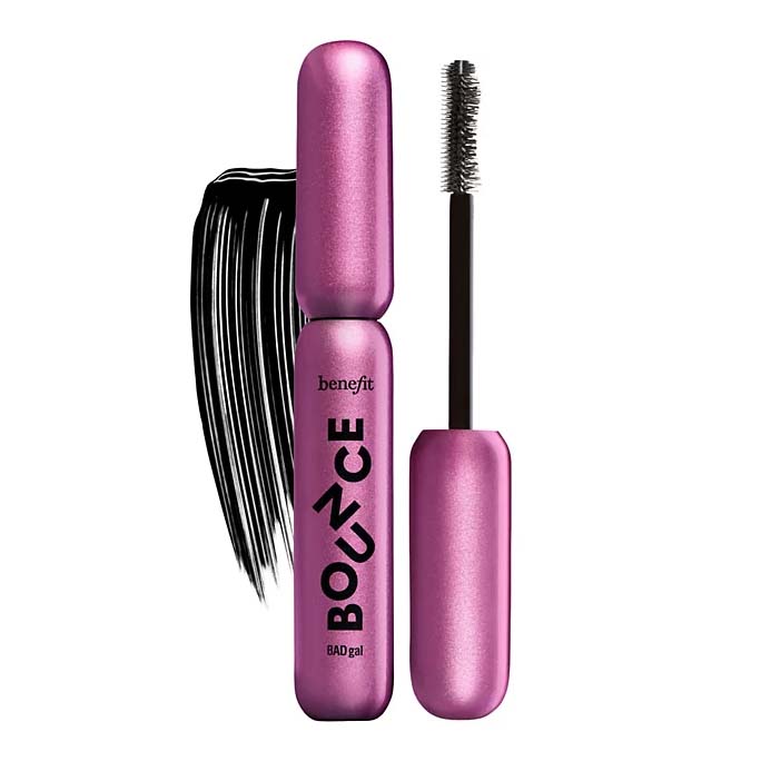 Pink mascara tube labeled \“Benefit BADgal BOUNCE\“ with an open brush and a swipe of black mascara.