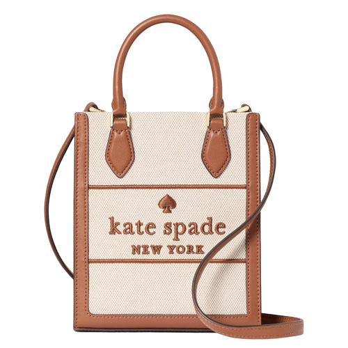A beige and brown Kate Spade New York tote bag with two handles and a shoulder strap, featuring the brand's logo on the front.