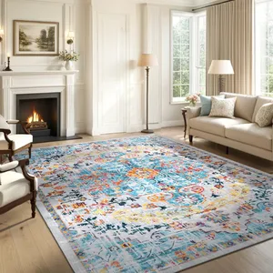 A living room with a large, colorful area rug featuring a vibrant floral and abstract pattern. The space includes a fireplace, cream-colored sofa, light armchair, and standing lamps set against a backdrop of large windows with beige curtains.