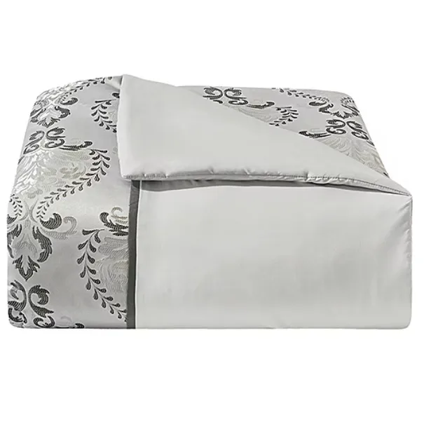 A folded duvet cover featuring a decorative black and gray pattern on one side and a solid light gray color on the other.