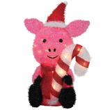 A pink light-up pig figurine wearing a Santa hat, black mittens, and a red scarf, holding a striped candy cane.