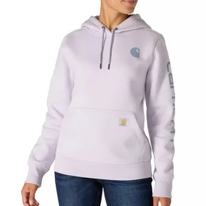 A woman is wearing a light purple Carhartt hoodie with a kangaroo pocket and the brand's logo on the chest and sleeve, paired with dark blue jeans.