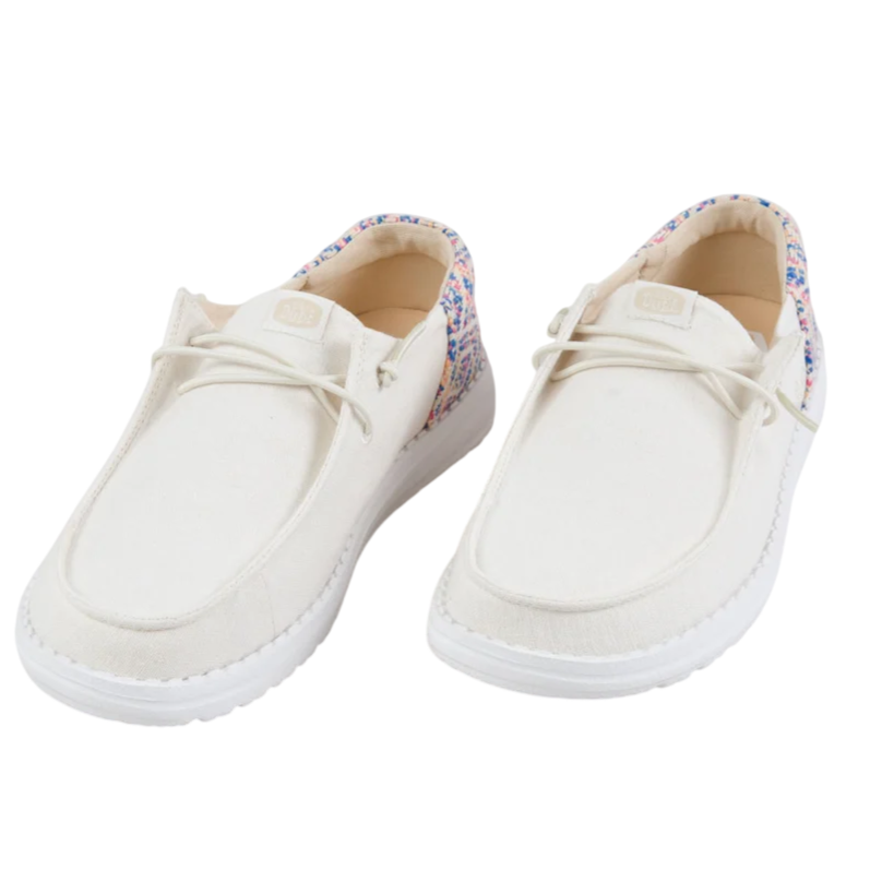 White casual shoes with colorful, multicolored detailing on the heel area, featuring a slip-on design and white soles.