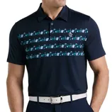 A navy polo shirt features a pattern of colorful cocktail illustrations across the chest, complemented by a white belt.
