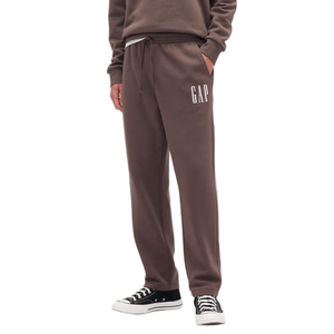 Brown sweatpants with \“GAP\“ logo, featuring an elastic waistband, drawstring, and side pockets; paired with black and white sneakers.
