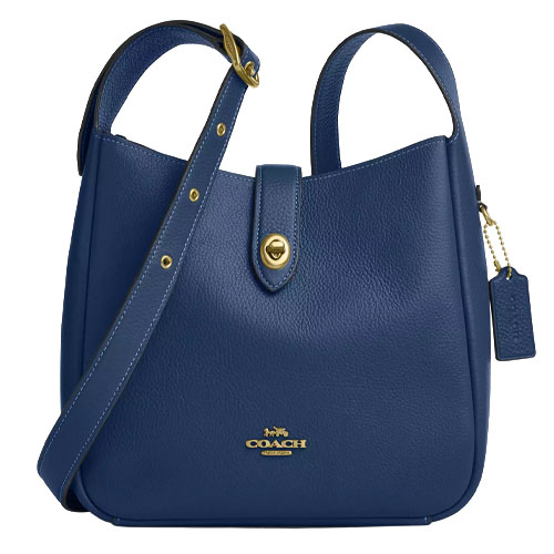 Blue leather Coach handbag with a gold-tone turn-lock closure and adjustable strap, featuring the Coach logo embossed on the front.