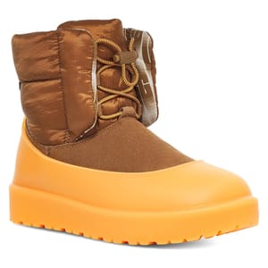 The UGG Classic Maxi Toggle Mini Boot features a quilted brown upper with toggle lacing and a bright orange waterproof shell and platform sole, combining style with functionality for cold weather.