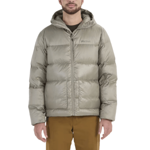 A person is wearing a light gray Marmot puffer jacket with a hood, paired with brown pants.