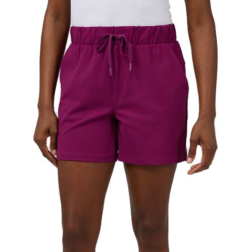 A person is wearing purple athletic shorts with an elastic waistband and a drawstring, paired with a white top.