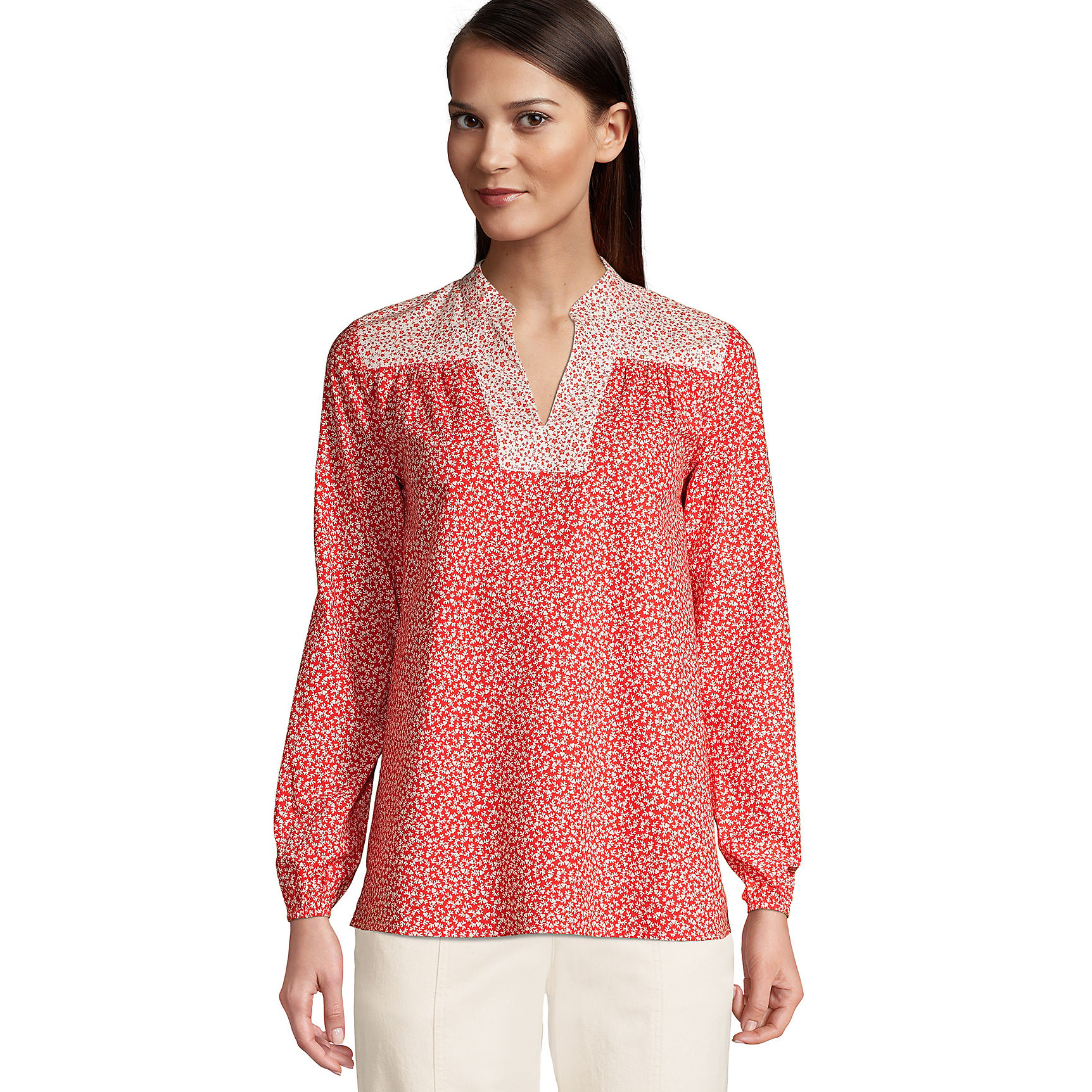 Red and white floral print peasant shirt with a V-neckline and contrasting patterned yoke, featuring long sleeves and a relaxed fit, paired with white pants.