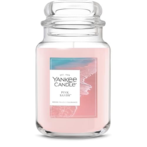 Yankee Candle in the Pink Sands scent, featuring a pink color and room-filling fragrance, with a coastal-themed label.