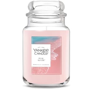 Yankee Candle in the Pink Sands scent, featuring a pink color and room-filling fragrance, with a coastal-themed label.