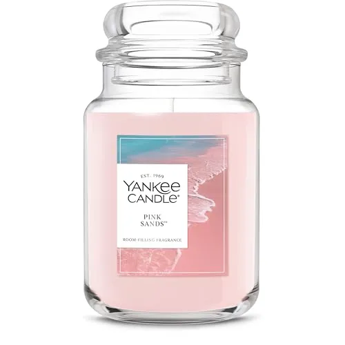 Yankee Candle in the Pink Sands scent, featuring a pink color and room-filling fragrance, with a coastal-themed label.