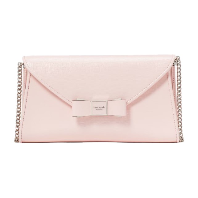 A pale pink Kate Spade crossbody bag featuring a flap closure with a bow detail and a chain strap.