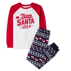 Holiday-themed pajama set with \“Team Santa 2024\“ baseball-style shirt and patterned pants featuring candy canes and Santa hats.