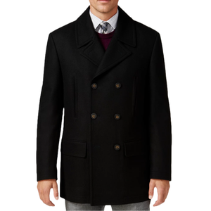 A man is wearing a black, double-breasted peacoat with wide lapels and slanted pockets. The coat is paired with a dress shirt, tie, and sweater.