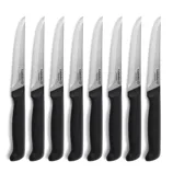 A set of eight serrated steak knives with black handles and stainless steel blades, branded as \“Calphalon Premier.\“