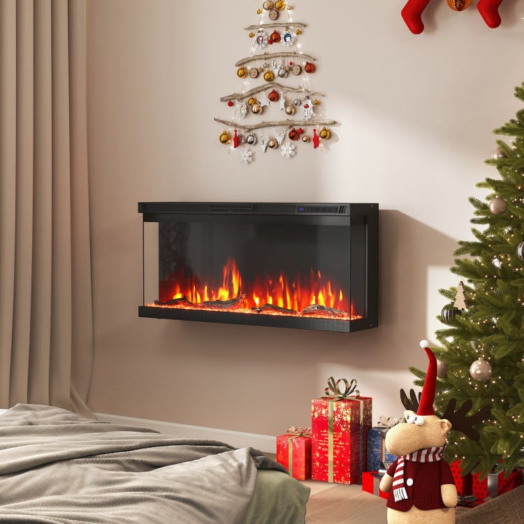 Wall-mounted electric fireplace with realistic flames, accompanied by a small wall tree with decorations, a plush reindeer, wrapped gifts, and a traditional Christmas tree.