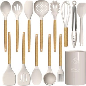 A set of kitchen utensils with wooden handles, including spatulas, spoons, a pasta server, tongs, a whisk, a can opener, and a brush, plus a storage caddy.