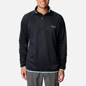 A man wearing a black long-sleeve pullover with a logo on the chest and teal accents at the collar and hem.