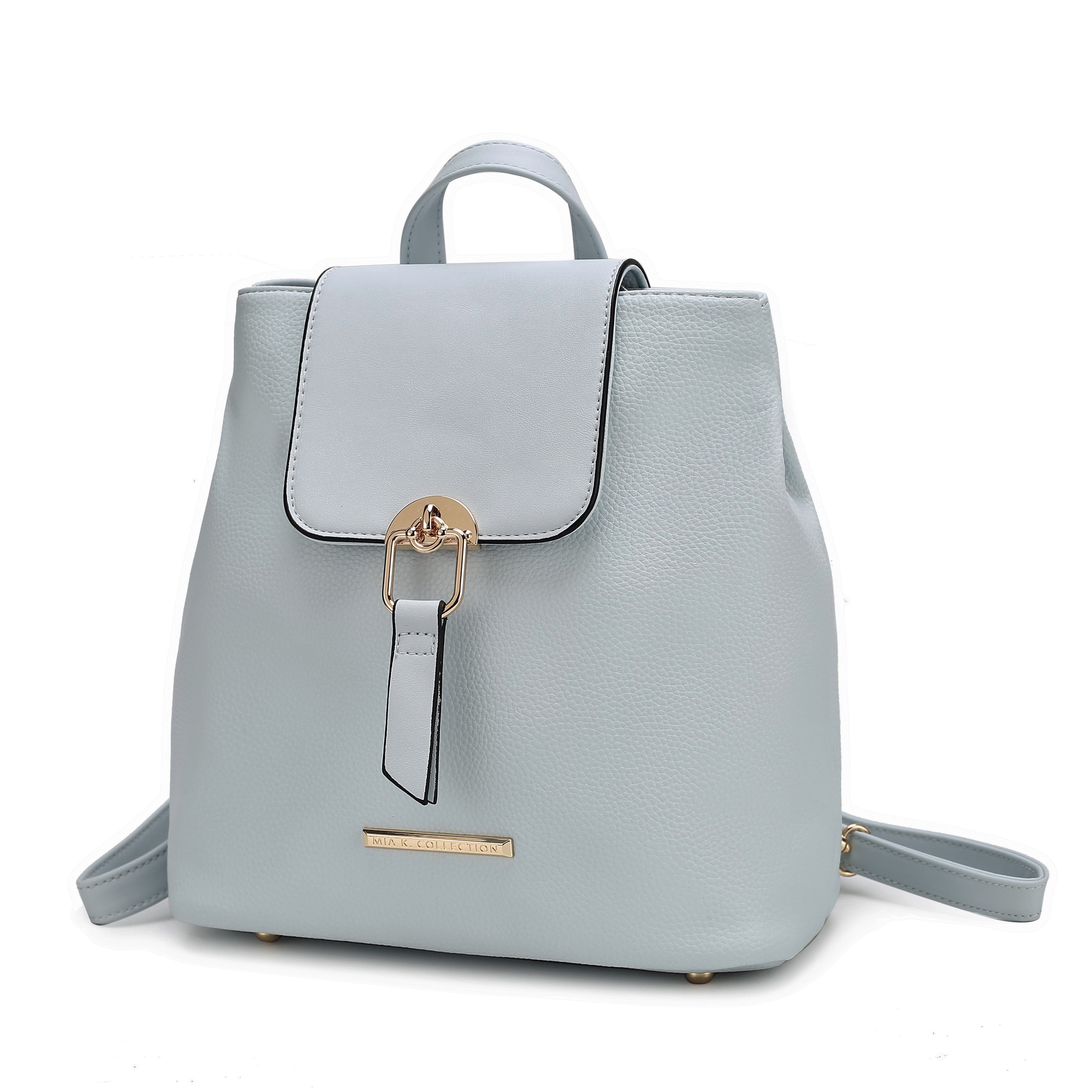 Light blue leather backpack with a flap closure, gold buckle, and adjustable straps. Features a small gold logo tag on the front.