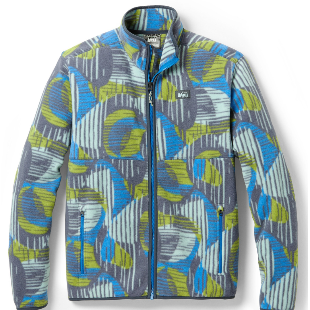 A patterned fleece jacket with a zipper front and chest pocket, featuring blue and yellow abstract designs on a gray background.